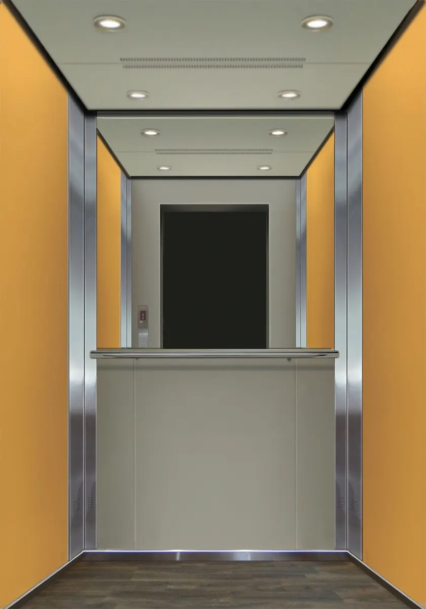 Passenger cabin with amber side panels, brushed steel returns and a wood-finish floor